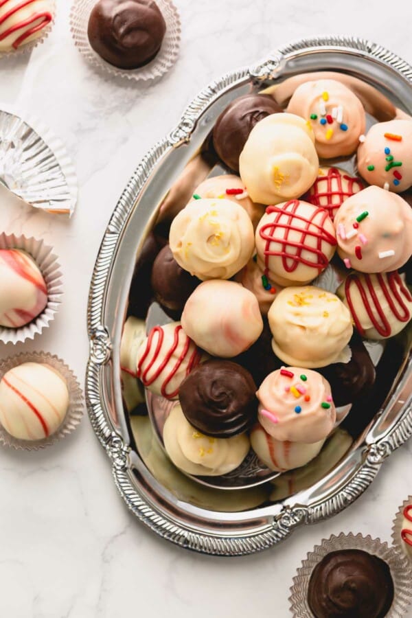 Colorful oreo balls on a silver serving platter.