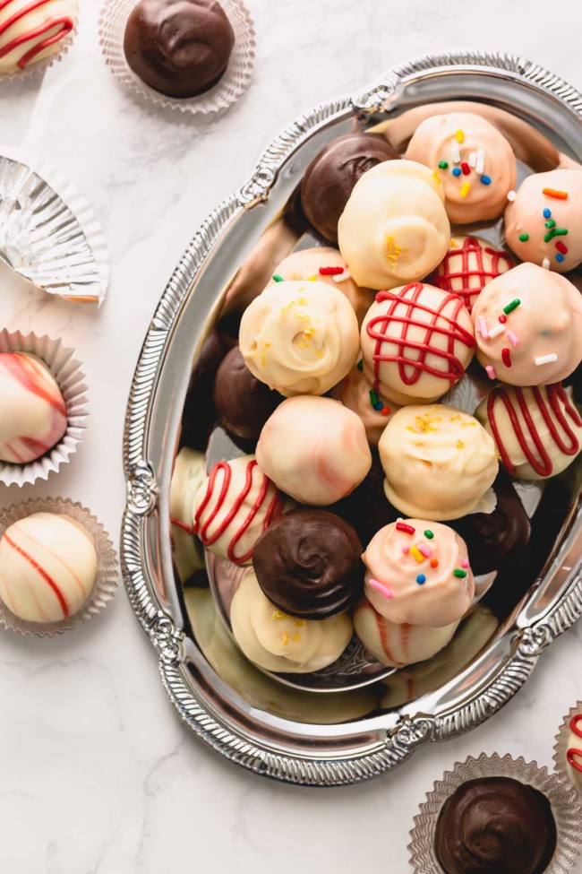 Colorful oreo balls on a silver serving platter.