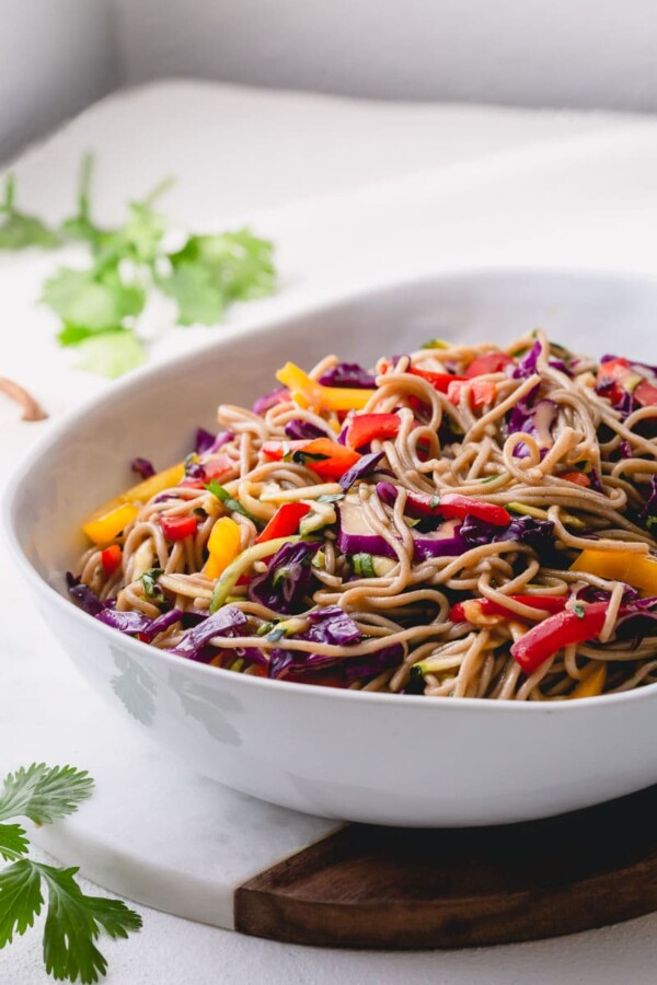 This Asian noodle salad is made with nutty soba noodles and rainbow of vegetables.  Bursting with Asian flavors, this light, flavorful and healthy side dish is a perfect addition to any BBQ dish! #asiannoodlesalad #noodlesalad