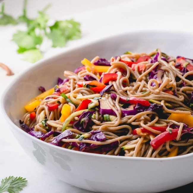 This Asian noodle salad is made with nutty soba noodles and rainbow of vegetables.  Bursting with Asian flavors, this light, flavorful and healthy side dish is a perfect addition to any BBQ dish! #asiannoodlesalad #noodlesalad