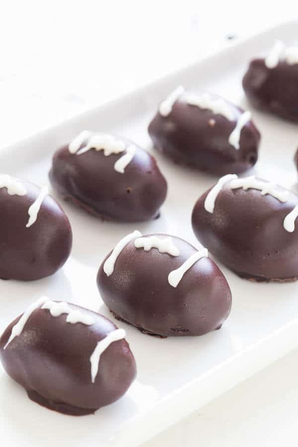 Bring the game spirit to your dessert table with these triple chocolate OREO cookie balls, dressed as an American football!