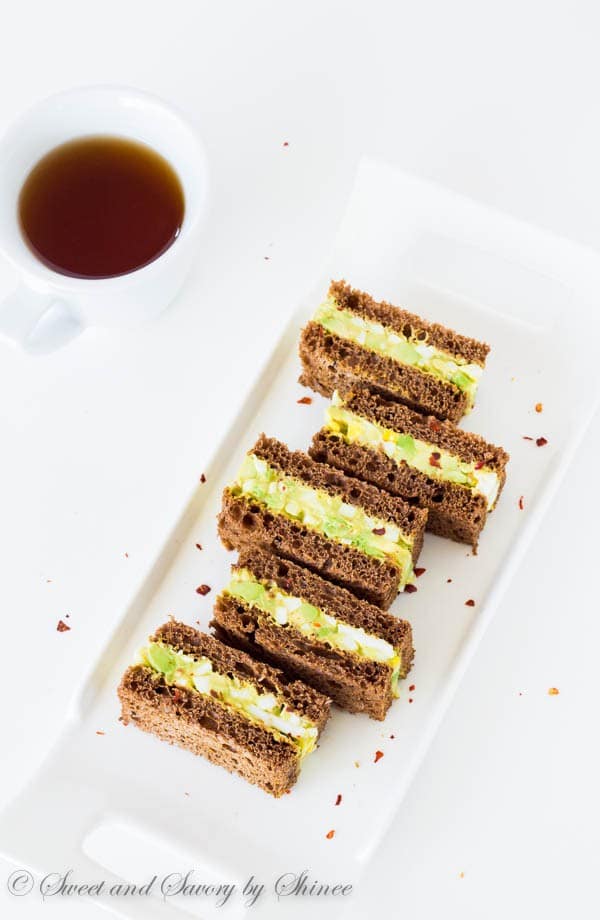 Spicy avocado egg salad sandwiched between chewy pumpernickel bread slices. Perfect texture contrast and flavor combination!