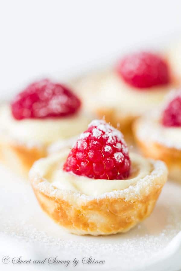 These little flaky tart shells filled with silky smooth lemon cream filling and topped with juicy fresh raspberries are completely from scratch with just 6 ingredients. 