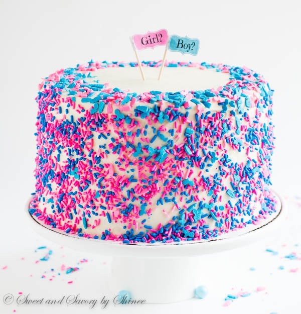 Tall 6-layer white cake covered with sweet and tangy cream cheese frosting and filled with colorful candies and sprinkles inside. Deliciously fun way to reveal the gender of a new bundle of joy!