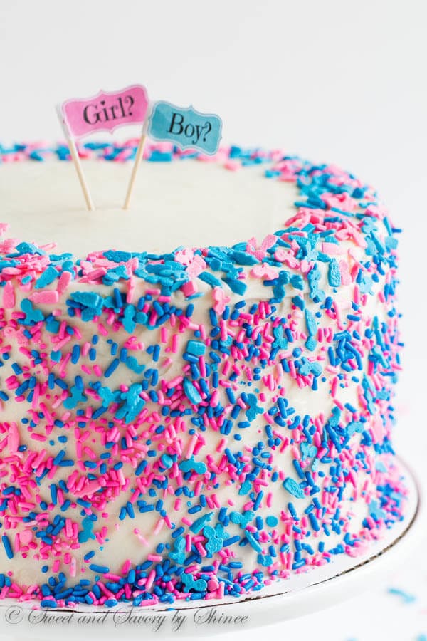 Tall 6-layer white cake covered with sweet and tangy cream cheese frosting and filled with colorful candies and sprinkles inside. Deliciously fun way to reveal the gender of a new bundle of joy!
