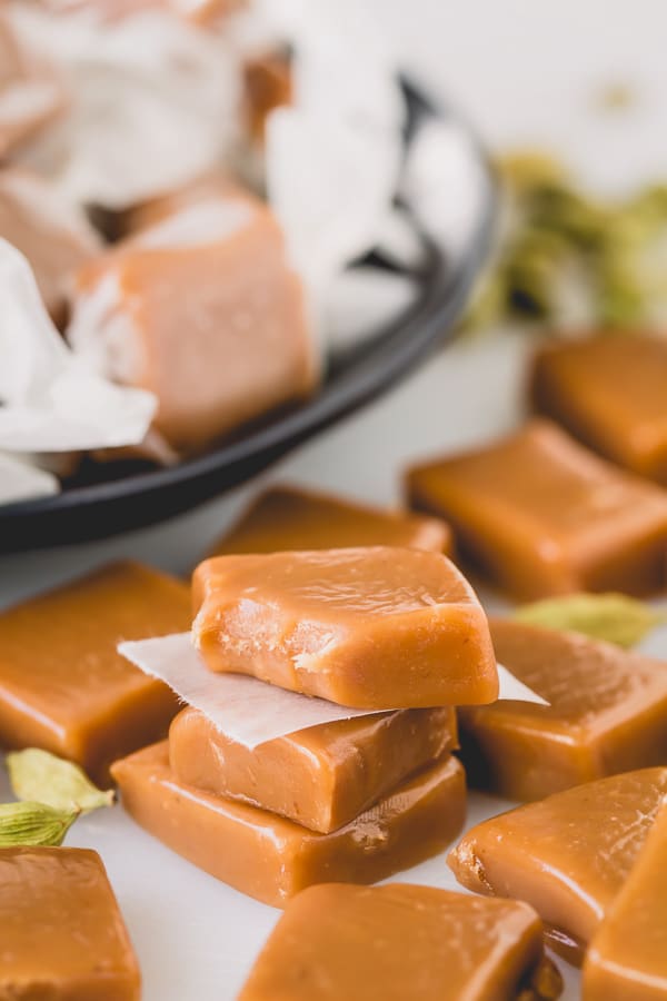 These buttery, soft and chewy caramel candies, infused with hint of cardamom, are so delightfully addicting!! Step-by-step photos and lots of tips included. #caramels #homemadecaramels