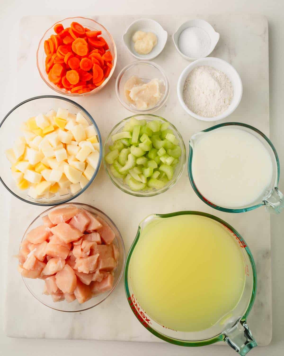 Ingredients for knoephla soup in individual bowls.