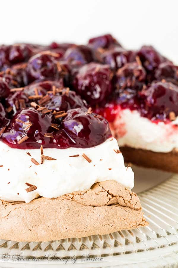 Melt-in-your-mouth light Chocolate Pavlova topped with indulgent sweet cherry sauce. Learn exactly how I make this show-stopper step by step.