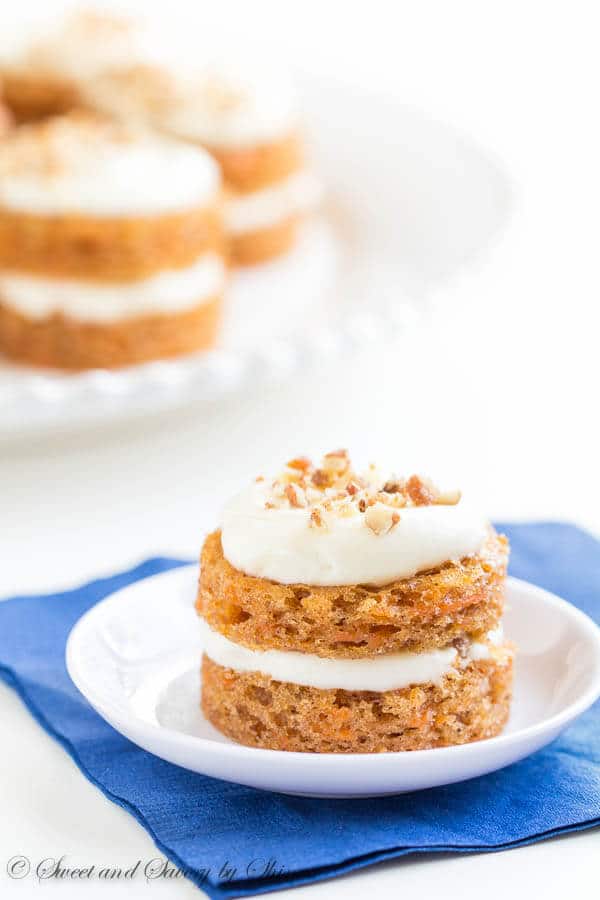 Adorable mini carrot cakes filled with classic cream cheese frosting and studded with crunchy candied pecans! It's the only way to eat carrot cake!