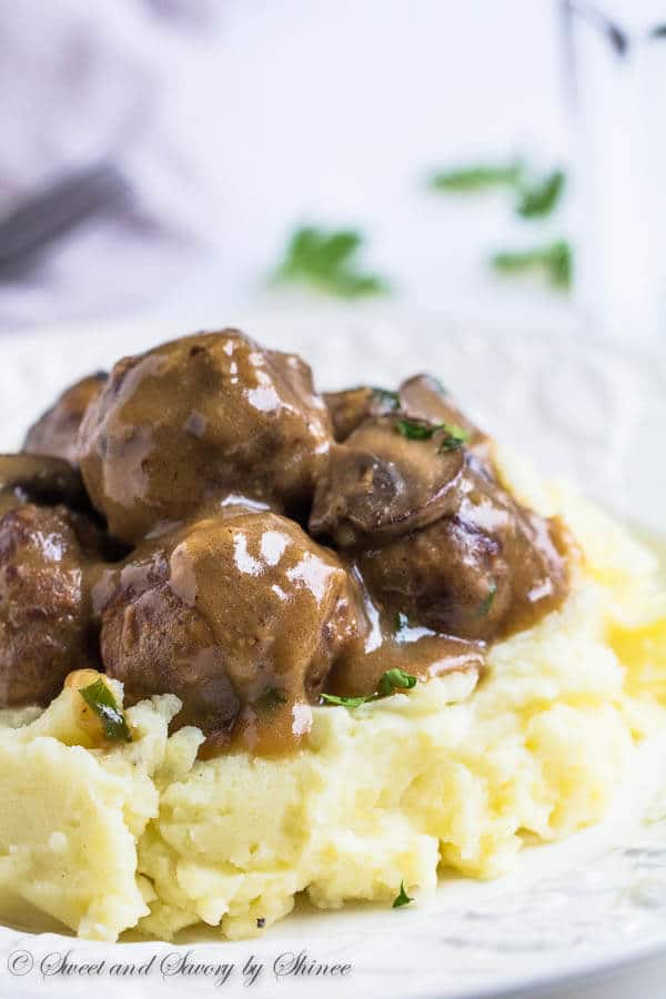 Juicy tender meatballs are first pan-fried for deliciously crispy exterior and then smothered in hearty mushroom gravy! Plus, learn how to make ton of meatballs for your freezer, step by step.
