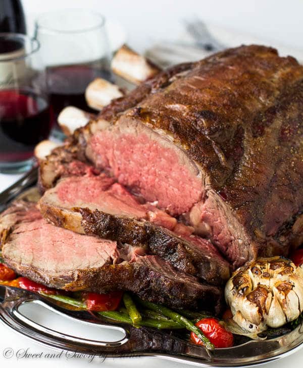 Chef de-boning and carving a portion of barbecued prime rib steak