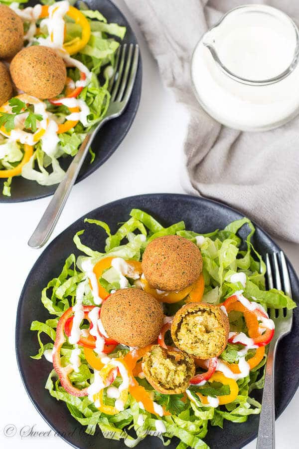 Simple satisfying salad, loaded with flavorful falafel balls and smothered with tangy Greek yogurt dressing. Customize yours with your favorite leafy greens and toppings. It's delicious summer lunch!