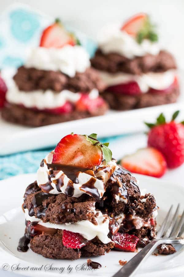 Irresistibly decadent twist on classic strawberry shortcakes! Try these tender and rich chocolate shortcakes filled with juicy strawberries and whipped cream. Additional drizzle of chocolate sauce is completely optional, but I know you wouldn't skip it.