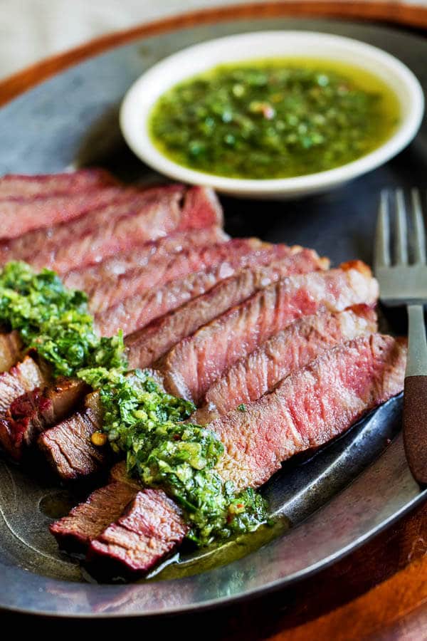 Melt-in-your-mouth tender ribeye steaks grilled to juicy perfection and paired with vibrant and aromatic chimichurri sauce! Simply perfect combination, and it takes only minutes to get dinner on the table.