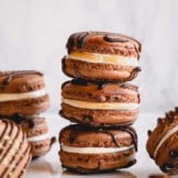 Filled s'mores macarons arranged on a counter.