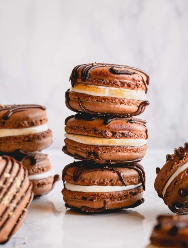 Filled s'mores macarons arranged on a counter.