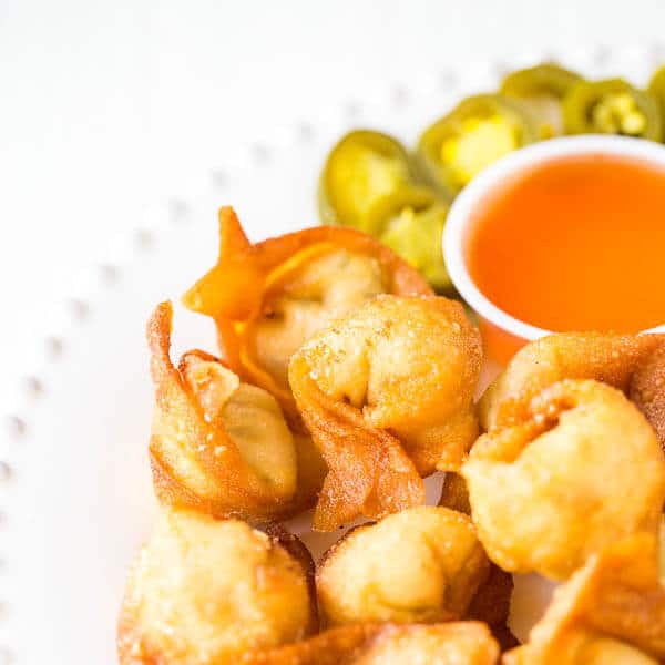 Super crispy wontons with smooth cream cheese filling with a kick. Homemade version of your favorite take-out appetizer with the same irresistibly delicious and addicting taste! Plus, a video tutorial on how to fold wontons 4 different ways.
