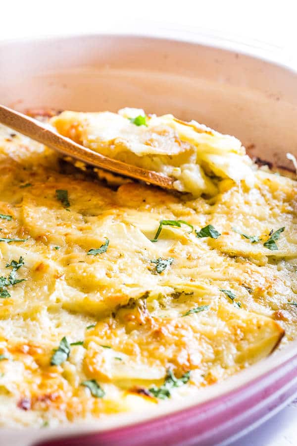 This family favorite cheesy scalloped potatoes are famous for its creamy richness and delicate cheesy layers. Excellent make-ahead side dish for a crowd!