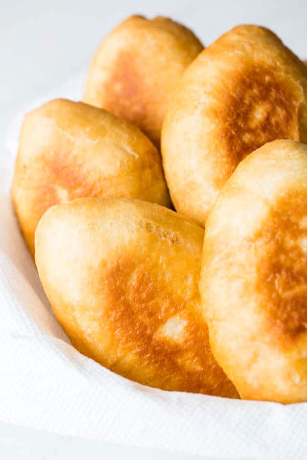 I'm sharing my mom's secret to the softest and fluffiest piroshki (Russian hand pies) with simple beef and rice filling, but you can fill yours with whatever your heart desires.