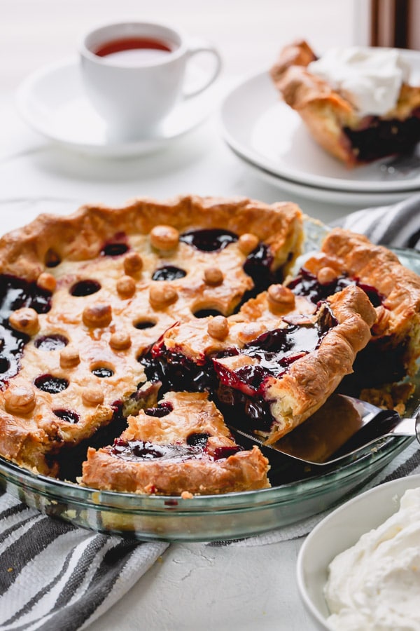 Homemade cherry pie with buttery flaky crust and thick cherry filling is easier than you may think! Besides my tried and tested recipe, you'll learn 3 tips to avoid runny cherry pie filling and an easy way to make a fun pie crust design. #cherrypie