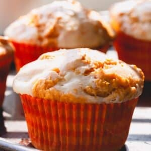 Pumpkin cheesecake muffins in muffin liners.