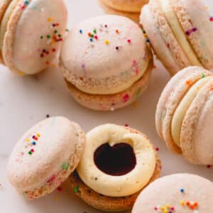 Filled funfetti macarons on a white background.