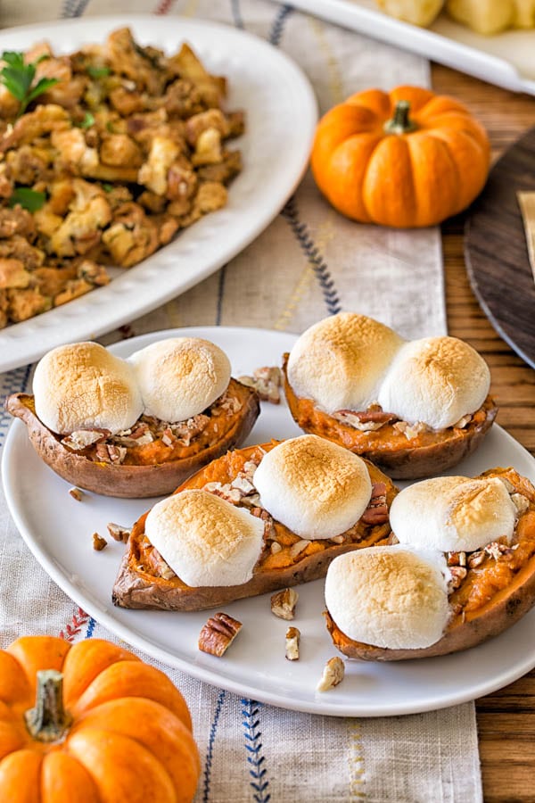 Baked sweet potato skins topped with toasted marshmallows and crunchy nuts! An irresistibly addicting side dish, perfect for holiday season!