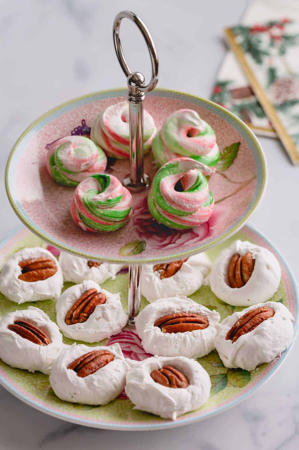 2-tiered serving platter of colored divinity on top and classic pecan divinity on the bottom.