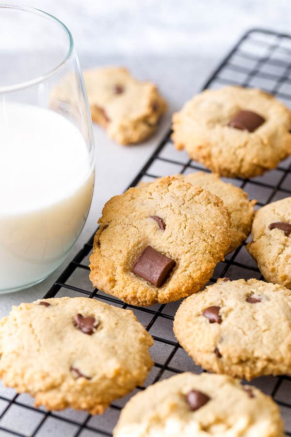 Gluten free chocolate chip cookies on cooling rack with glass of milk... These cookies are insanely easy and quick to make!