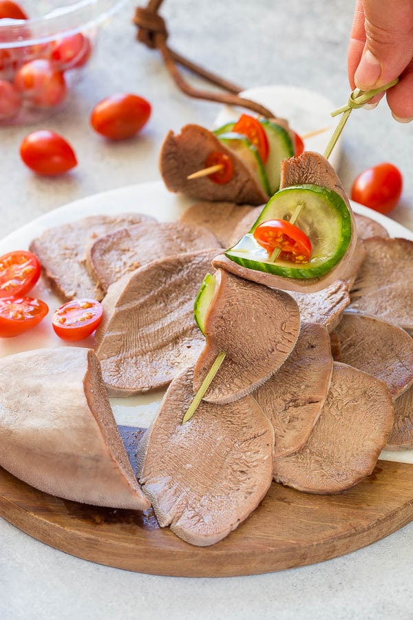 Slow cooked beef tongue is great as an appetizer with cucumbers and tomato! And so easy to prepare. #beeftongue #appetizer