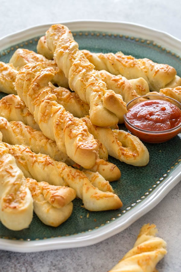 No-fail breadsticks infused with roasted garlic and laced with cheese inside and out. Unbelievably delicious, yet truly simple to make. #roastedgarlic #breadsticks #easybreadsticks