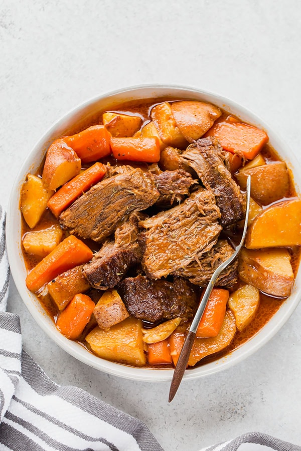 Cooking flavorful, well-marbled chuck roast (I used home-raised wagyu beef) low and slow in a dutch oven yields melt-in-your-mouth tender and unbelievably flavorful pot roast! Easy pot roast recipe for the BEST one pot meal! #potroast #onepotmeal #beefroast #wagyubeef #comfortfood