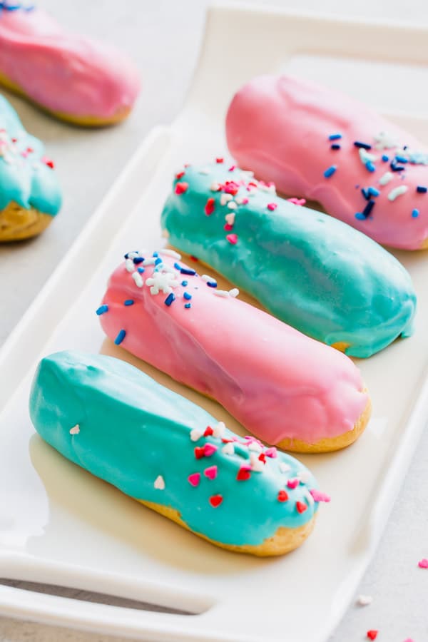 Sprinkle little fun with these cute little gender reveal eclairs to break the news! It's such a sweet way to share fun news. #genderreveal #eclars #genderrevealpartyideas