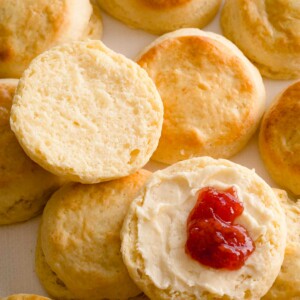 Sliced scone with butter and jam.