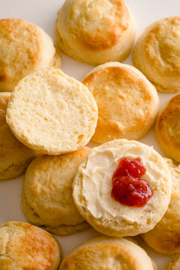 Sliced scone with butter and jam.