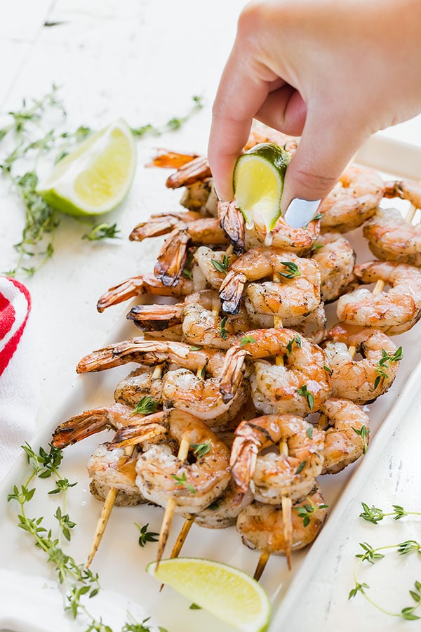 Slightly spicy, slightly smoky and absolutely delicious Jamaican Jerk shrimp is about to become your new favorite summer meal! Comes together quick and easy, these succulent shrimp skewers are delicious with plain white rice. #easydinner #appetizer #shrimpskewers #jamaicanjerkshrimp #grilledshrimp