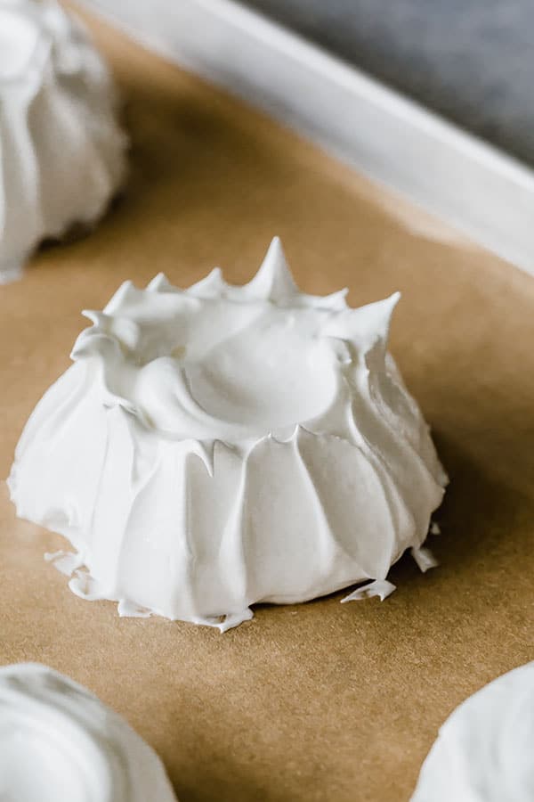 Elevate the simple mounds with this simple trick: swipe up the sides of the meringue with a back of spoon.