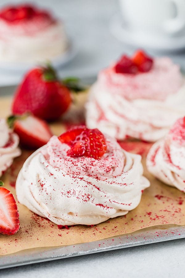Dreamy, creamy and oh-so-delicate strawberry mini Pavlova is light and sweet mini desserts to impress your guests! Equipped with my top 5 tips and simple ingredients, you'll make perfect Pavlova every time. #minipavlova #pavlovacake #bakingtips #easydessert #impressivedessert