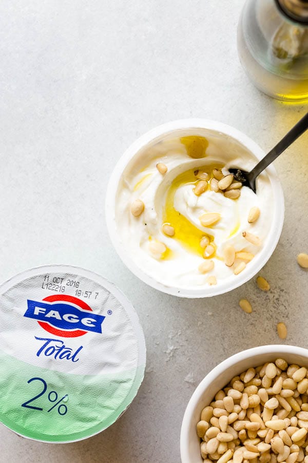 Unusual, but oh-so-savory, this yogurt bowl with olive oil, sea salt and pine nuts will definitely surprise your taste buds! #yogurtbar #snack #healthysnack #snacktime #yogurtbowl