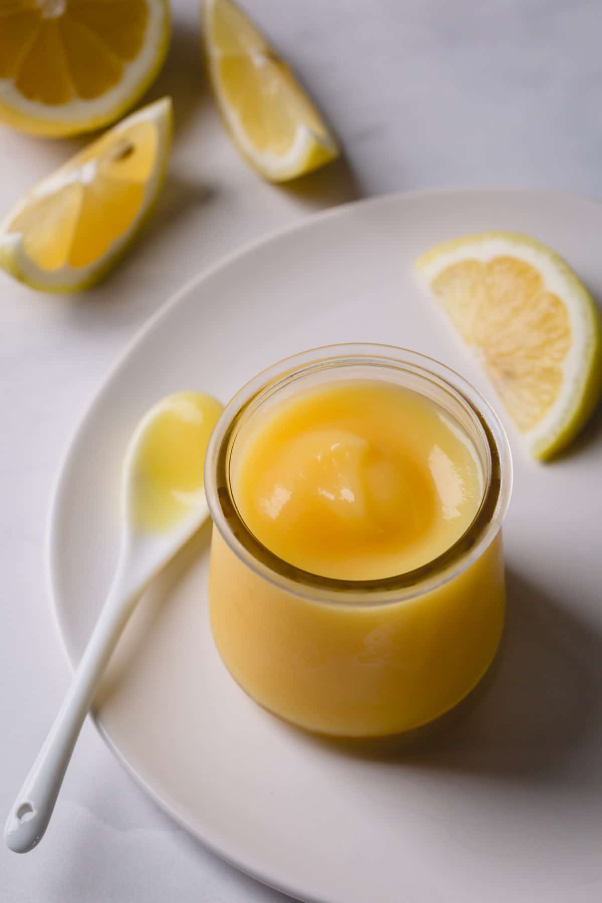 Creamy lemon curd in a glass jar.