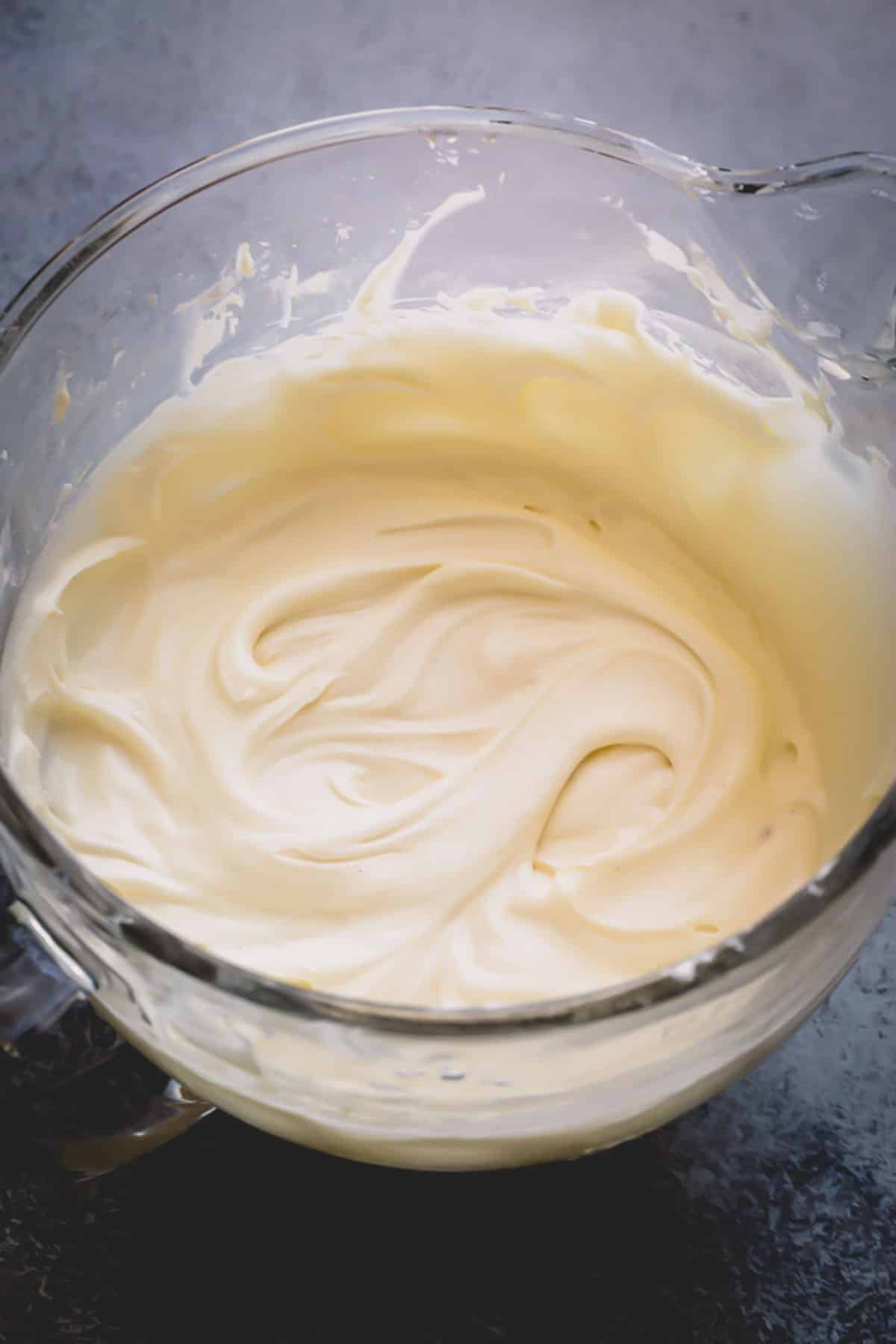 A glass bowl of smooth frosting.