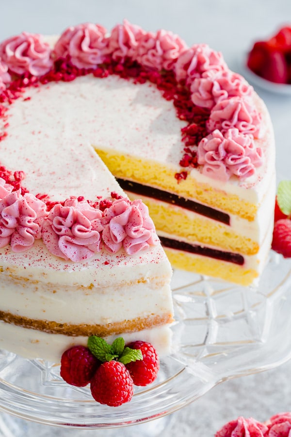 Delicate sponge cake layers filled with creamy sweet cream cheese frosting and raspberry jello made with real fruits. Gorgeous, tall and impressive cake for any occasion.