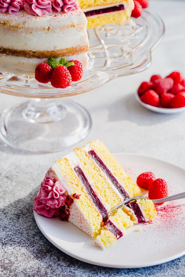 Delicate sponge cake layers filled with creamy sweet cream cheese frosting and raspberry jello made with real fruits. Gorgeous, tall and impressive cake for any occasion.