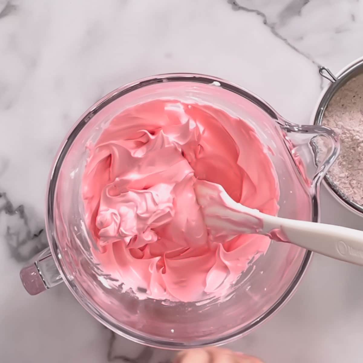 A glass bowl of pink meringue.