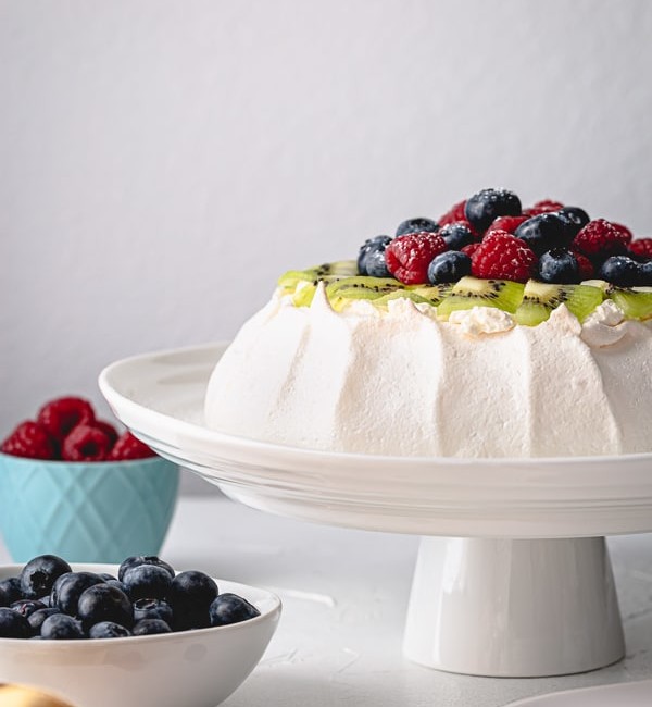 This classic meringue-based cake is light, airy and absolutely delicate dessert that never fails to impress. #pavlovacake