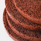 Sliced chocolate cake layers stacked on top of each other.