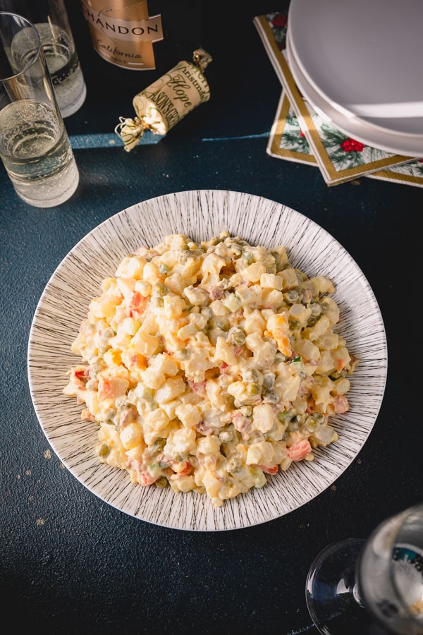 Olivier Salad, or Russian potato salad, is a meal on its own. Loaded with lots of vegetables, meats and eggs and finished with creamy mayo, this Russian salad is so satisfying and filling! #russiansalad #russianpotatosalad #oliviersalad