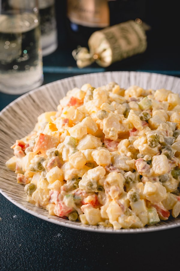 Olivier Salad, or Russian potato salad, is a meal on its own. Loaded with lots of vegetables, meats and eggs and finished with creamy mayo, this Russian salad is so satisfying and filling! #russiansalad #russianpotatosalad #oliviersalad