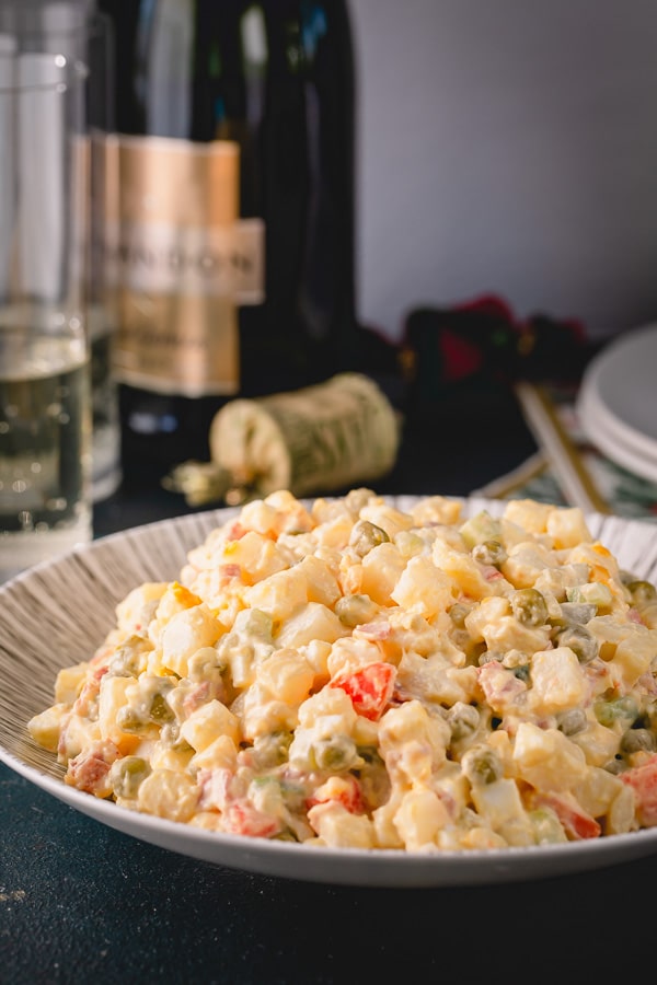 Olivier Salad, or Russian potato salad, is a meal on its own. Loaded with lots of vegetables, meats and eggs and finished with creamy mayo, this Russian salad is so satisfying and filling!  #russiansalad #russianpotatosalad #oliviersalad