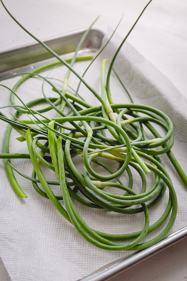 3 BEST things to do with garlic scapes. Learn how to prepare scapes, how to store and deliciously simple ways to use those versatile long greens!